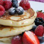 Fluffy Coconut Flour Pancakes Topped with Fresh Berries