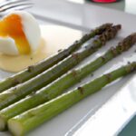 Elevate Brunch: Poached Eggs on Asparagus Drizzled with Olive Oil