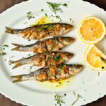 Golden Crispy Sardines Served with Zesty Lemon Wedges